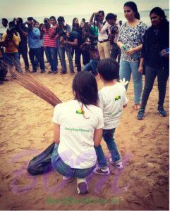 Divya Khosla Kumar with his son while cleaning up the beach