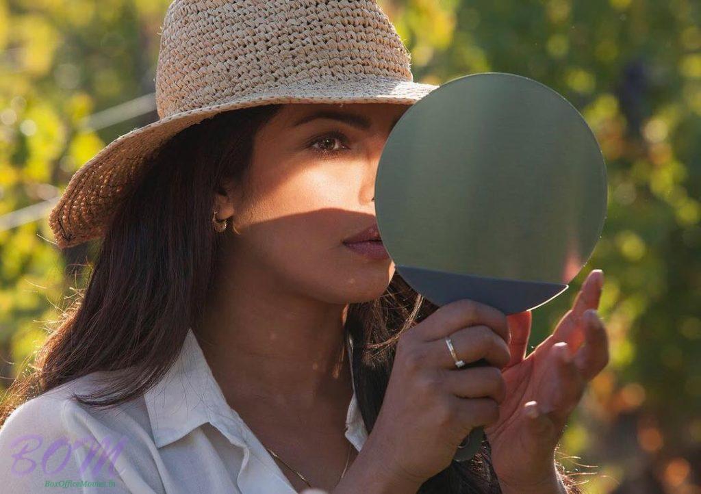 Priyanka Chopra double checking up her makeup before a shoot