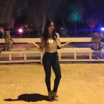 Elli Avram standing alone between tigers in Dubai