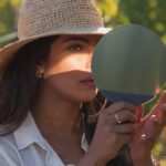 Priyanka Chopra double checking up her makeup before a shoot