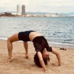 Taapsee Pannu doing chakrasana in Barcelona Beach sands