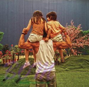 Tiger Shroff holding kids in his both shoulders